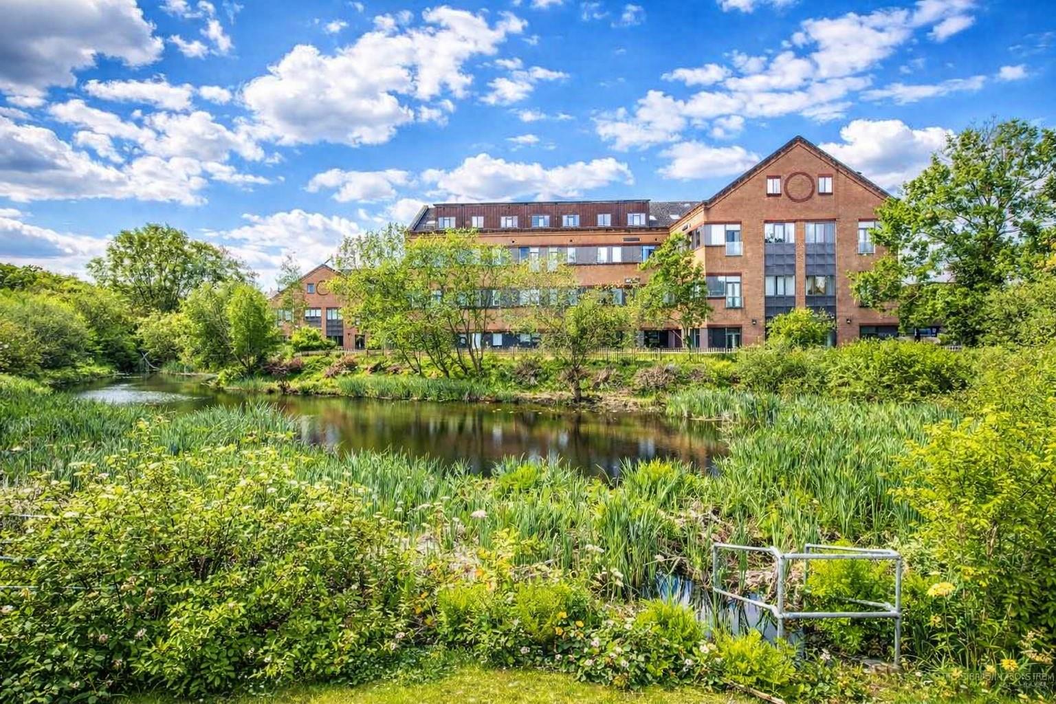 Hampshire acquisition, residential building beside a pond